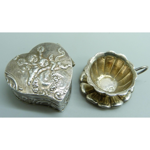 7255 - A miniature continental silver cup and saucer and a silver heart shaped pill box, both with import s... 