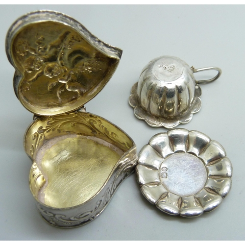 7255 - A miniature continental silver cup and saucer and a silver heart shaped pill box, both with import s... 