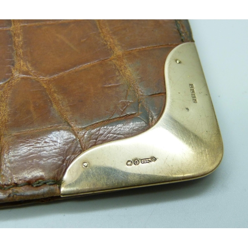 7264 - A 9ct gold mounted leather wallet, 10.5cm x 16.5cm