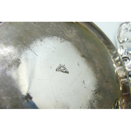 7269 - An embossed silver dish, Birmingham 1908, and a hammered dish marked sterling, 125g