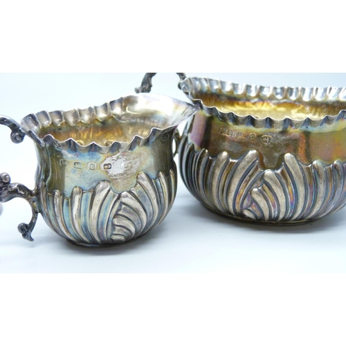 7271 - A silver cream and sugar, a silver salt and a pair of silver vases, total weight 236g, (vases a litt... 