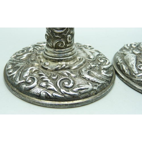 7274 - A pair of embossed silver candlesticks, 9.5cm