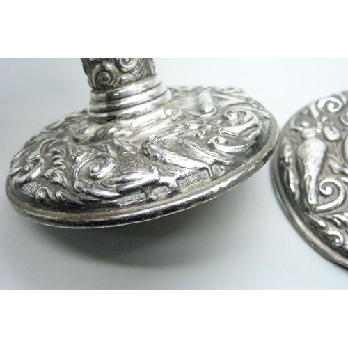 7274 - A pair of embossed silver candlesticks, 9.5cm