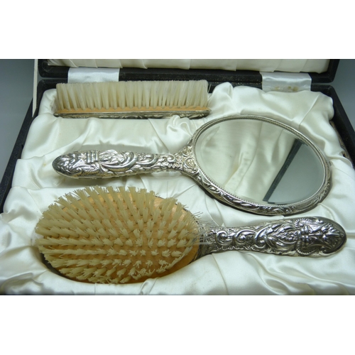 7277 - An embossed silver vanity set in a fitted case