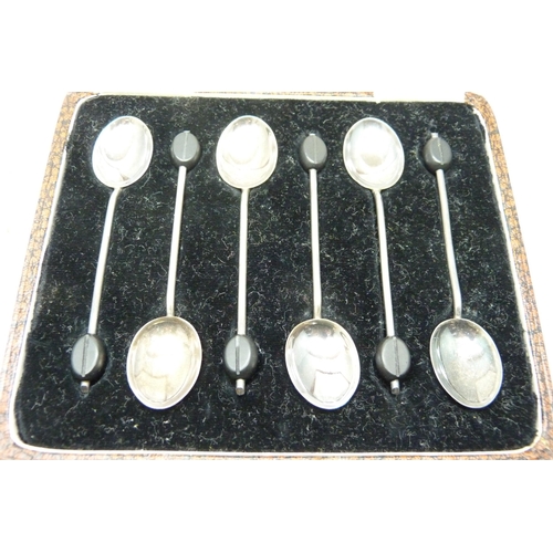 7279 - A set of six silver coffee bean spoons, 36g, and a silver candlestick with enamel, a/f