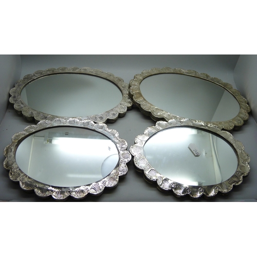 7284 - Four medium and small embossed white metal wall mirrors, (medium 15cm x 20cm)