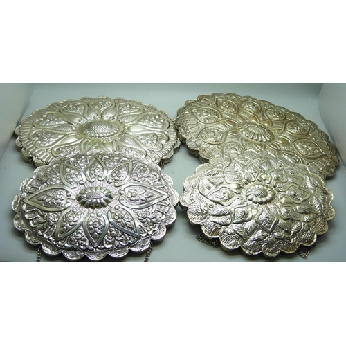 7284 - Four medium and small embossed white metal wall mirrors, (medium 15cm x 20cm)