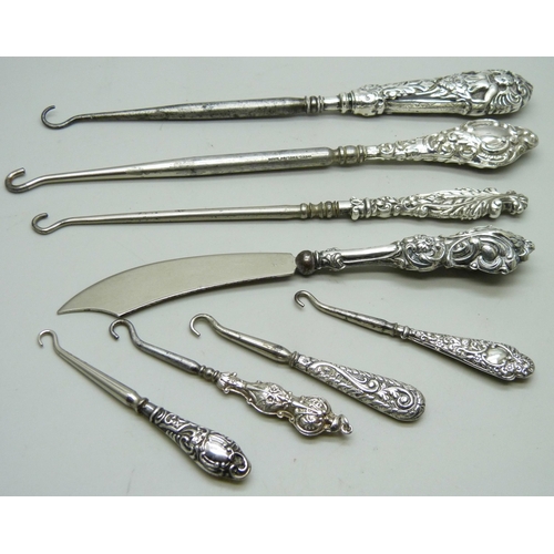 7285 - Silver handled button hooks and a paper knife