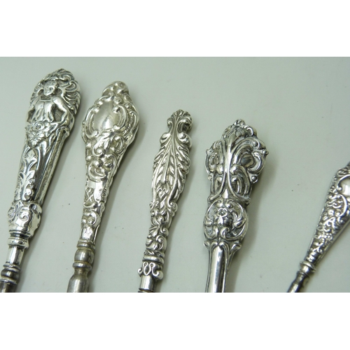 7285 - Silver handled button hooks and a paper knife