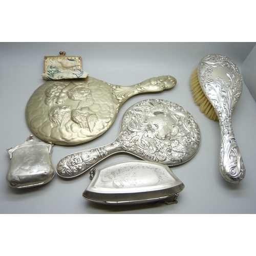 7286 - Two silver purses, 126g, a silver backed brush, a silver backed mirror, one other mirror and one oth... 