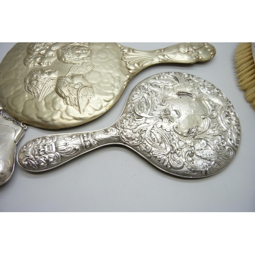 7286 - Two silver purses, 126g, a silver backed brush, a silver backed mirror, one other mirror and one oth... 