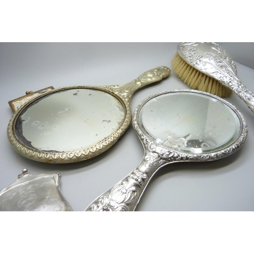 7286 - Two silver purses, 126g, a silver backed brush, a silver backed mirror, one other mirror and one oth... 