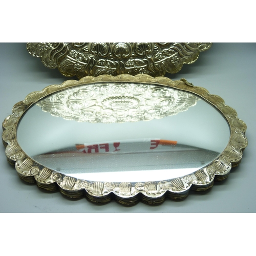 7293 - A pair of embossed white metal wall mirrors