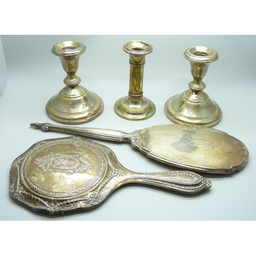 7294 - Three silver candlesticks and two silver hand mirrors