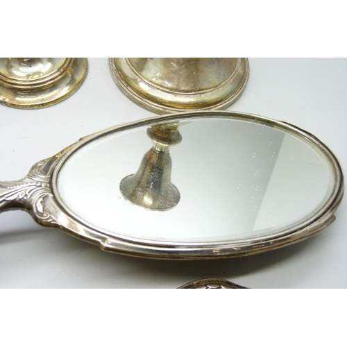 7294 - Three silver candlesticks and two silver hand mirrors