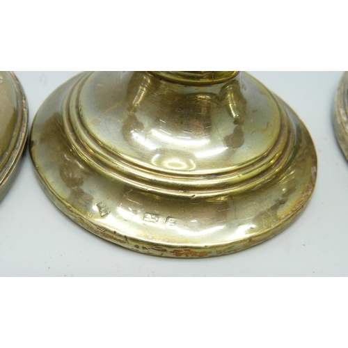 7294 - Three silver candlesticks and two silver hand mirrors