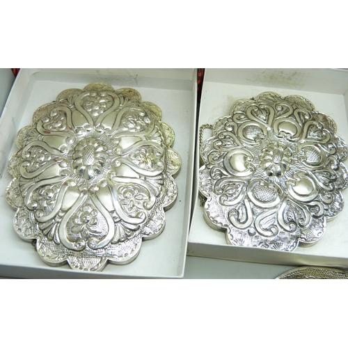 7297 - Five boxed embossed white metal wall mirrors and two others