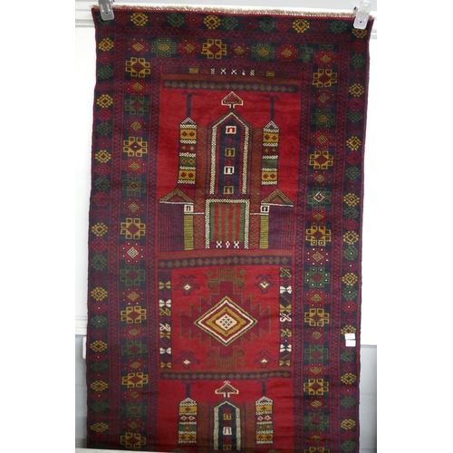 3036 - A rich red ground handwoven Afghan Baluch tribal rug