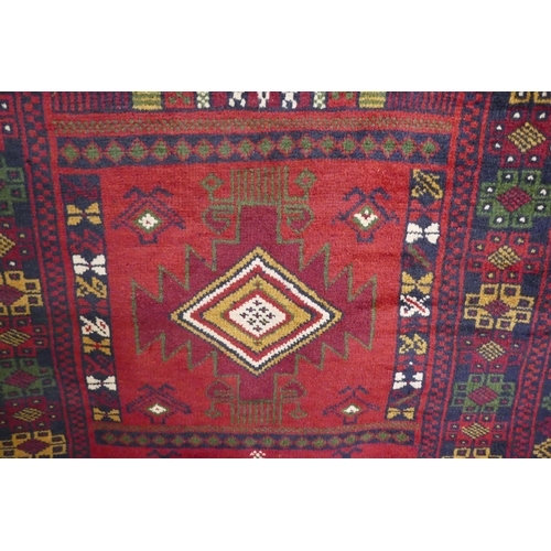 3036 - A rich red ground handwoven Afghan Baluch tribal rug