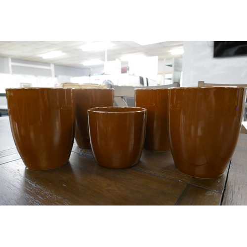 3108 - A set of five caramel painted plant pots in assorted sizes