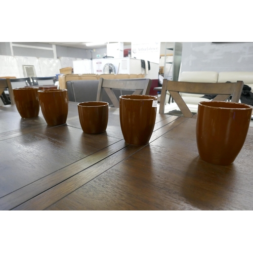 3108 - A set of five caramel painted plant pots in assorted sizes