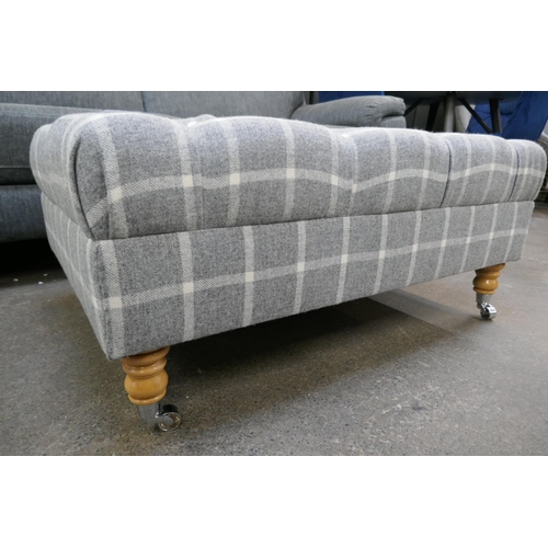 3175 - A grey checkered patterned upholstered deep button footstool on casters