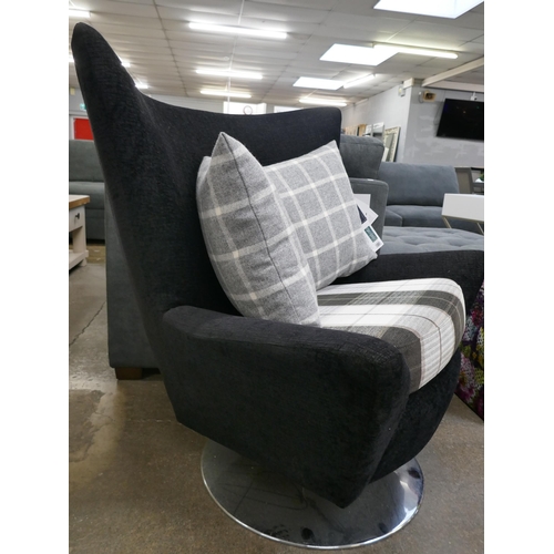 3182 - A black fabric tulip shaped swivel chair with patterned seat and scatter cushions