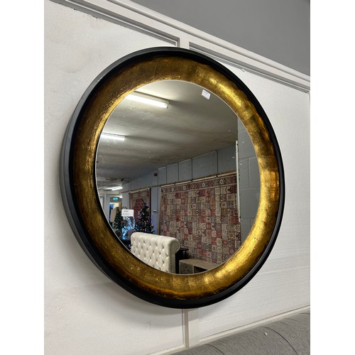 3040 - A black and gold painted large circular illuminated wall hanging mirror