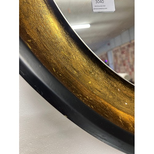 3040 - A black and gold painted large circular illuminated wall hanging mirror