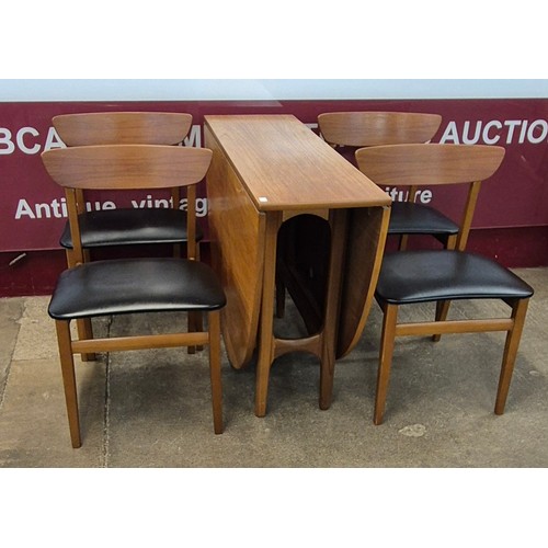 14 - A teak drop leaf table and four chairs