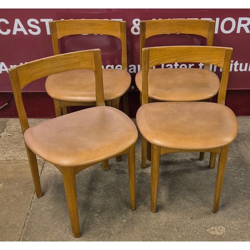 20 - A Nathan teak circular extending dining table and four chairs