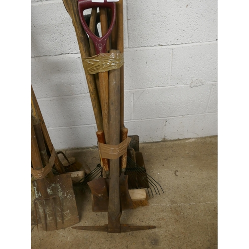 5158 - A quantity of garden tools including a pick axe, rakes, shovels, brushes pitchforks, etc.