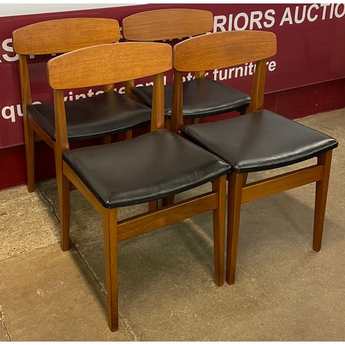 55 - A set of four teak and black vinyl dining chairs