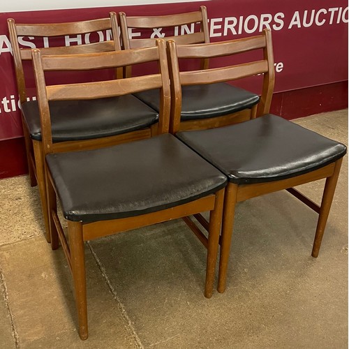 58 - A set of four teak and black vinyl dining chairs