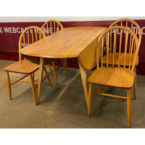 66 - An Ercol Blond elm Windsor dropleaf dining table and four elm and beech dining chairs