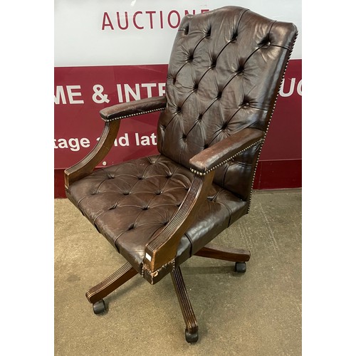 89 - A beech and chestnut brown leather Gainsborough style revolving desk chair