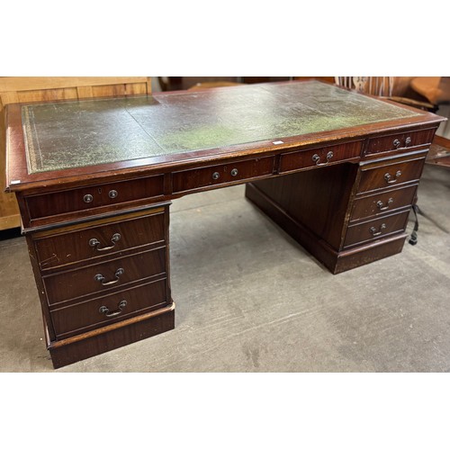 118 - A large mahogany and green leather topped library desk