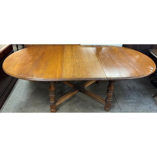 121 - An Ercol Golden Dawn ash extending dining table