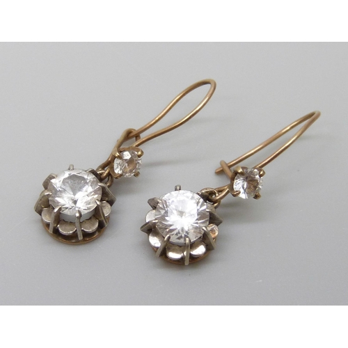 7002 - A pair of yellow metal drop earrings set with white stones, 1.9g