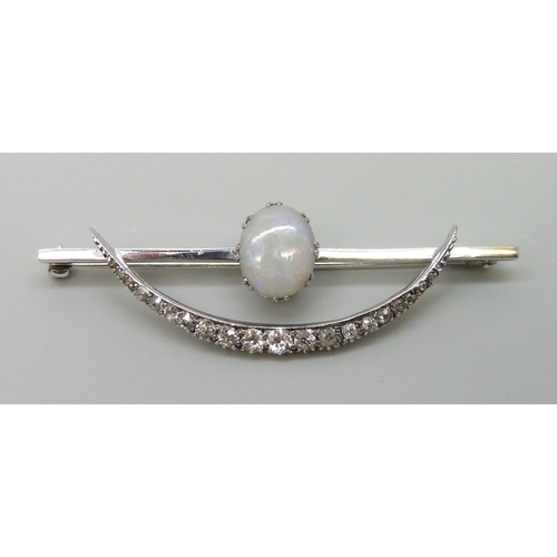 7009 - A white metal Art Deco brooch set with an opal and diamonds, 5.8g, 57mm