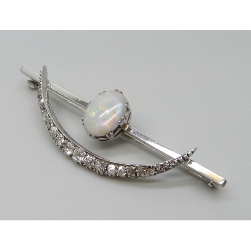 7009 - A white metal Art Deco brooch set with an opal and diamonds, 5.8g, 57mm