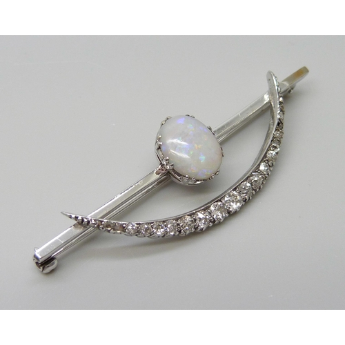 7009 - A white metal Art Deco brooch set with an opal and diamonds, 5.8g, 57mm