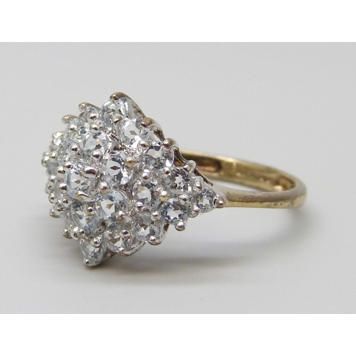 7023 - A 9ct gold and white stone cluster ring, 2.1g