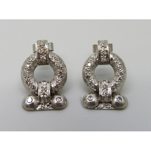 7026 - A pair of Art Deco white metal set diamond earrings, with box