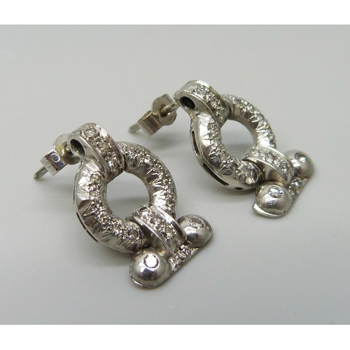 7026 - A pair of Art Deco white metal set diamond earrings, with box