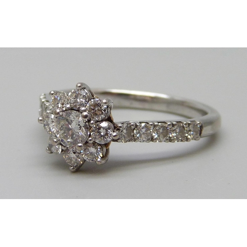 7029 - An 18ct white gold diamond flower cluster ring, estimated total diamond weight 1.00 carat, assessed ... 