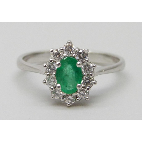 7032 - An 18ct gold, diamond and emerald ring, 2.6g, N