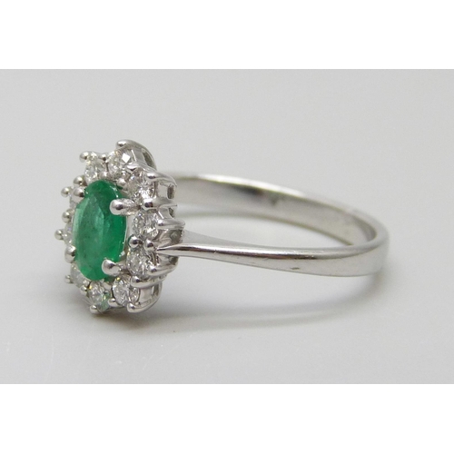 7032 - An 18ct gold, diamond and emerald ring, 2.6g, N