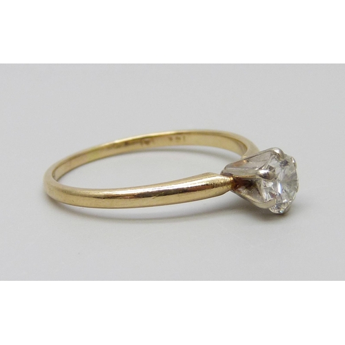 7033 - A yellow metal set diamond solitaire ring, approximately 0.70ct diamond weight, 1.8g, P