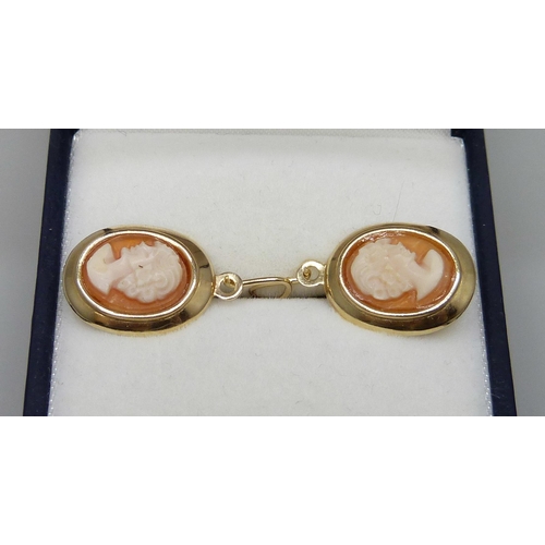 7043 - A pair of 9ct gold cameo earrings, a pair of 9ct gold cross earrings, two 9ct gold single earrings a... 